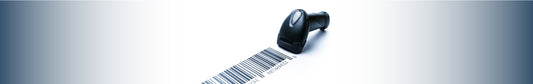 Close-up of a barcode next to a barcode scanner.